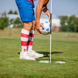 Footgolf Player Picking Soccer Ball from the Hole on the Golf Course